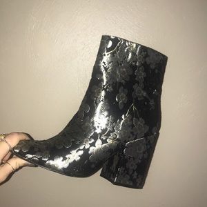 Black booties with silver flower embellishments